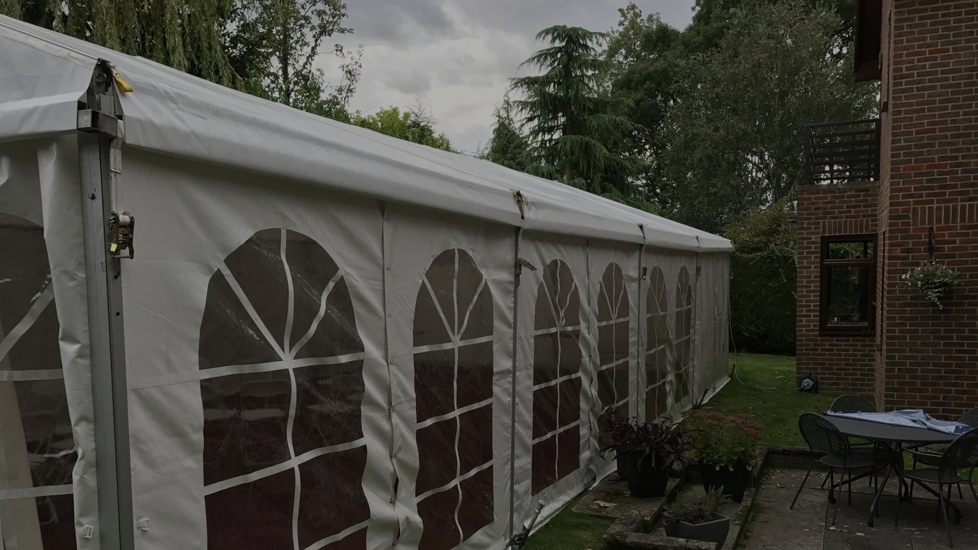 White marquee tent exterior setup in a garden