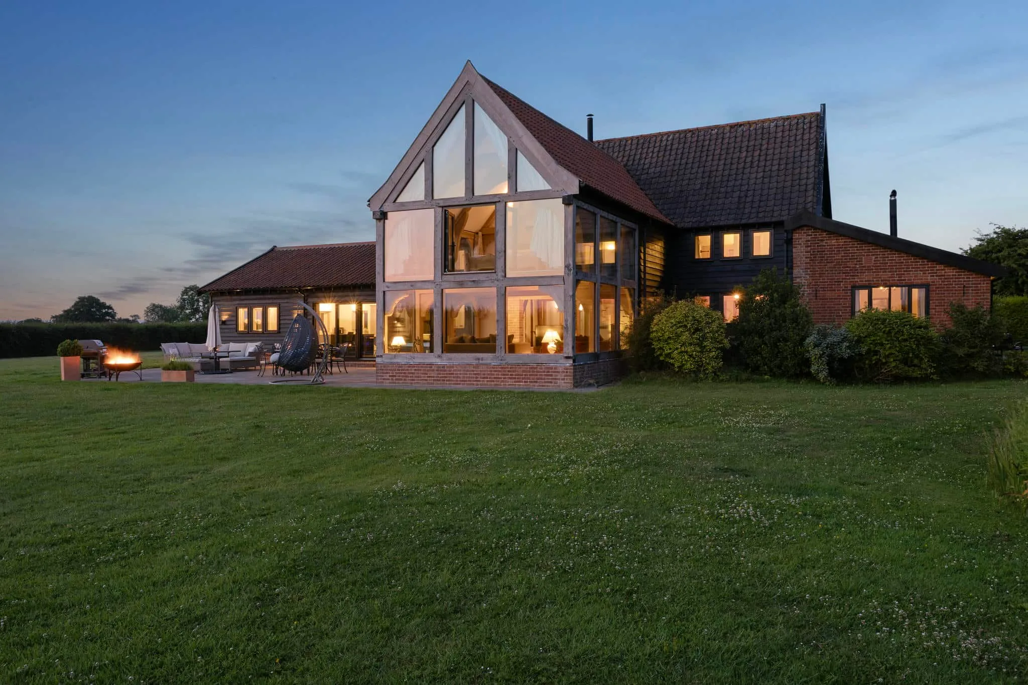 Modern barn conversion at twilight - Norfolk estate agent