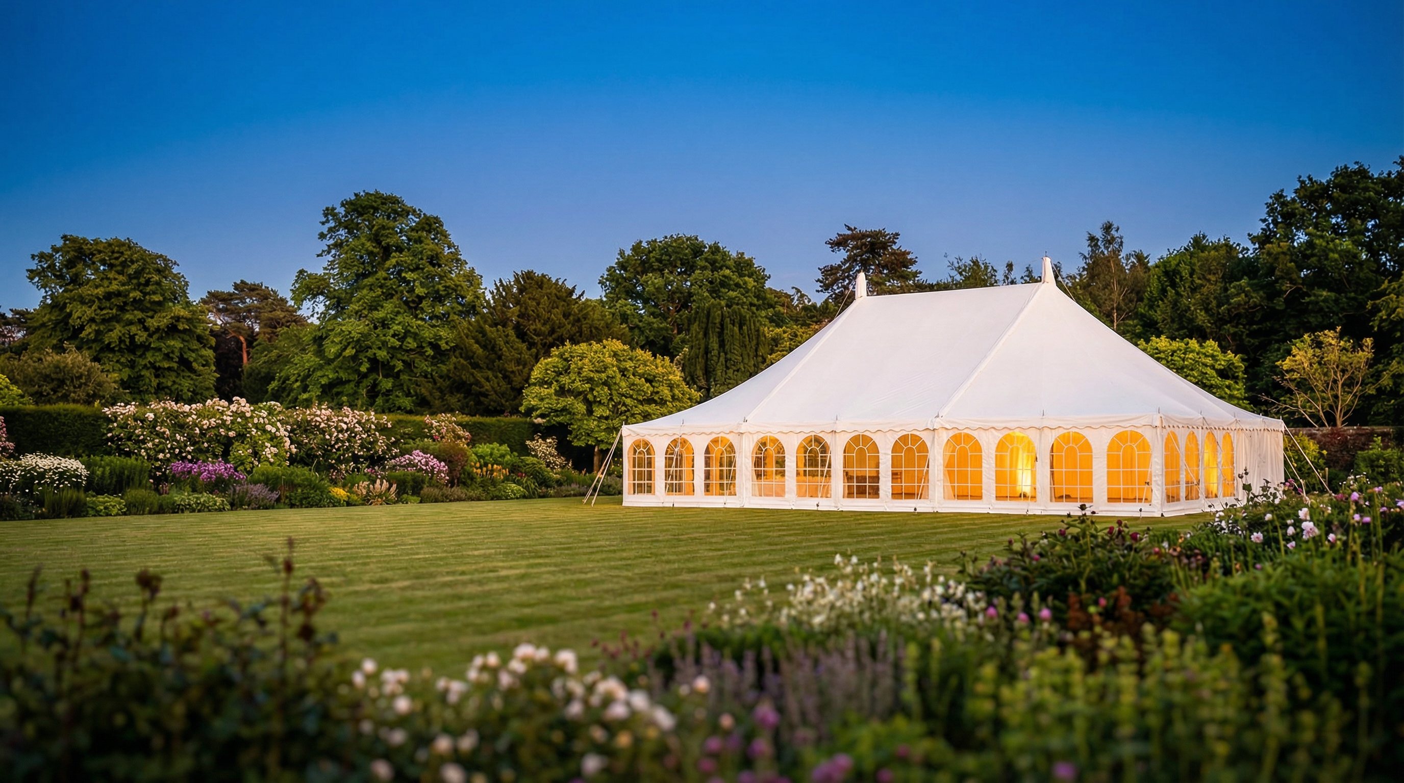 Elegant marquee set up in a beautiful English garden at golden hour